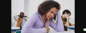 Student feeling stressed while concentrating on an exam